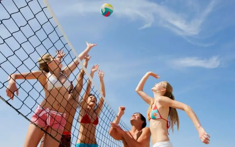 Volleyball playing on a sand field
